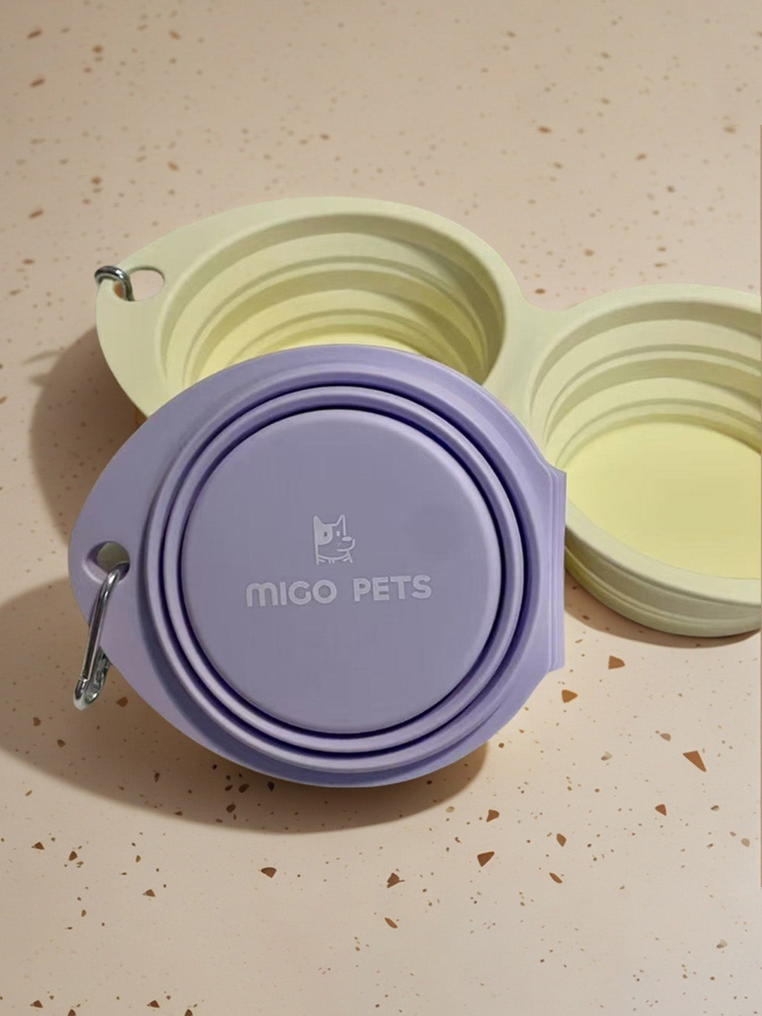 Collapsible travel double dog bowl, shown folded and partially opened for easy travel use.