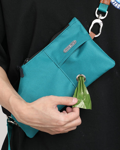 Close-up of the jade green durable crossbody travel pouch, showcasing its convenience for wearing and accessing waste bags.