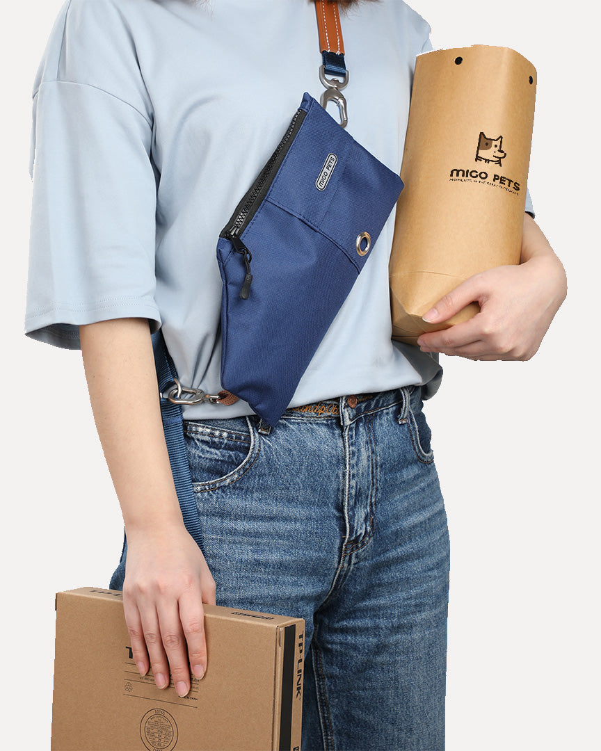 A person wearing a navy-blue crossbody travel pouch, freeing her hands for other tasks.