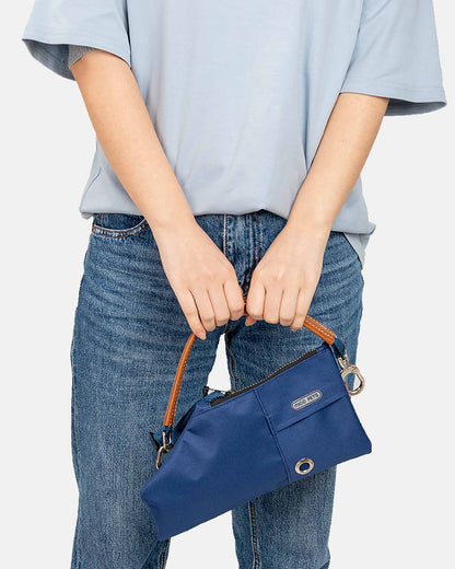 A person holding the navy blue durable crossbody travel pouch with an adjustable strap for added versatility.