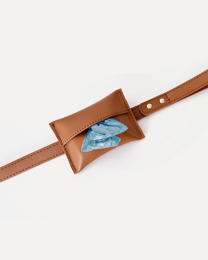 Close-up of the brown waterproof leather dog leash, highlighting the waste bag holder.