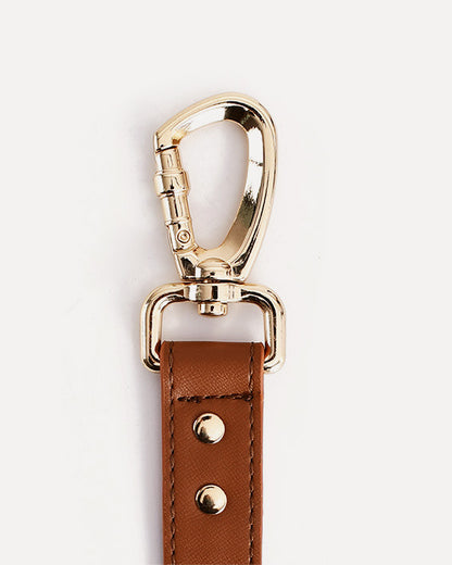 Close-up of the brown waterproof leather dog leash with bag holder, highlighting the metal clasp.